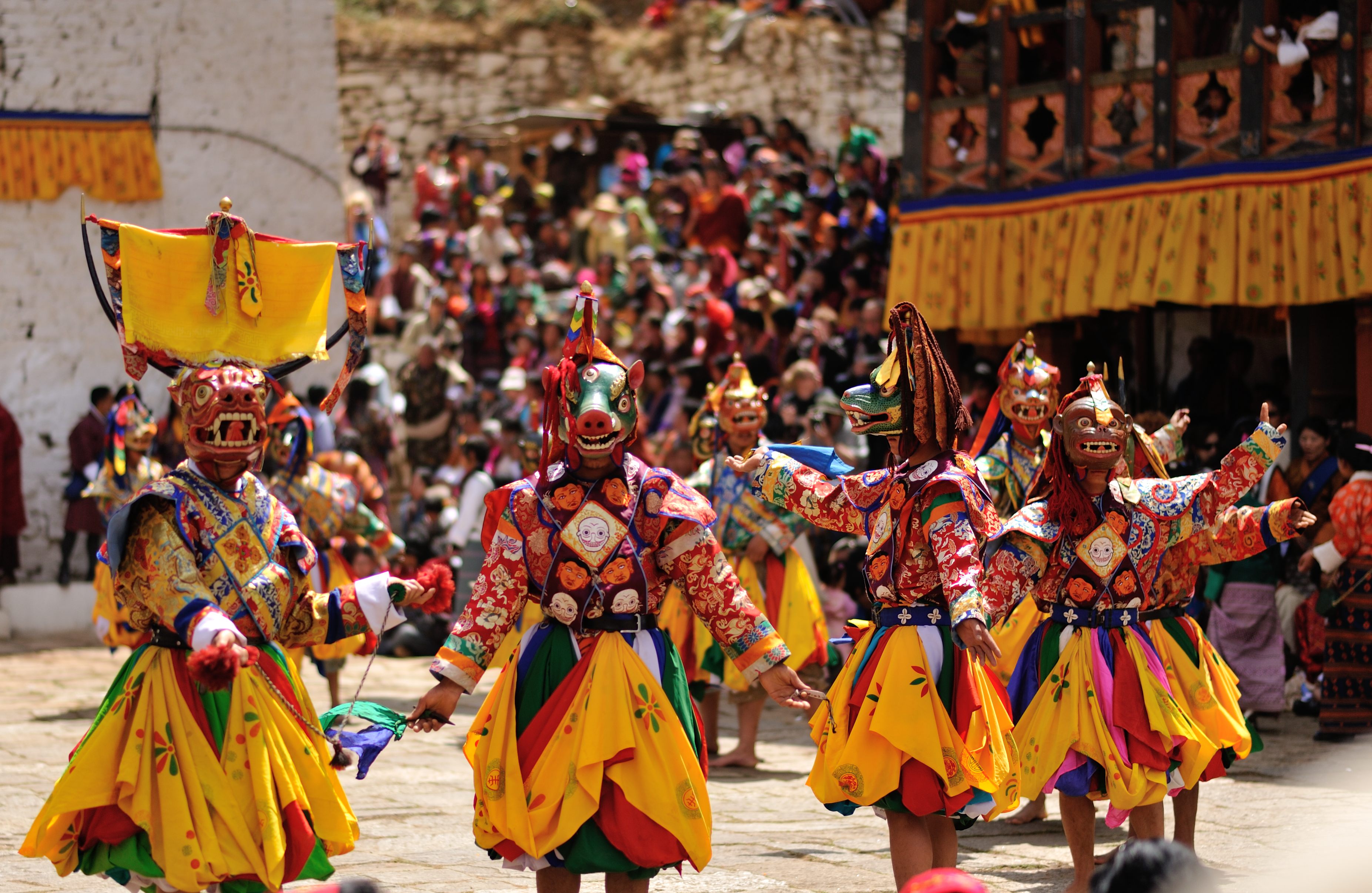 Masked dancers performing at a Bhutanese tshechu festival